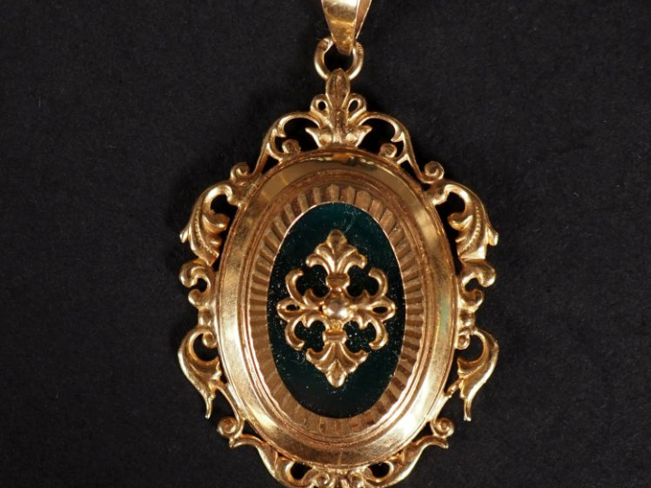Pendentif en or 750, décor de feuillage et de fleurs de lys, pierre ve