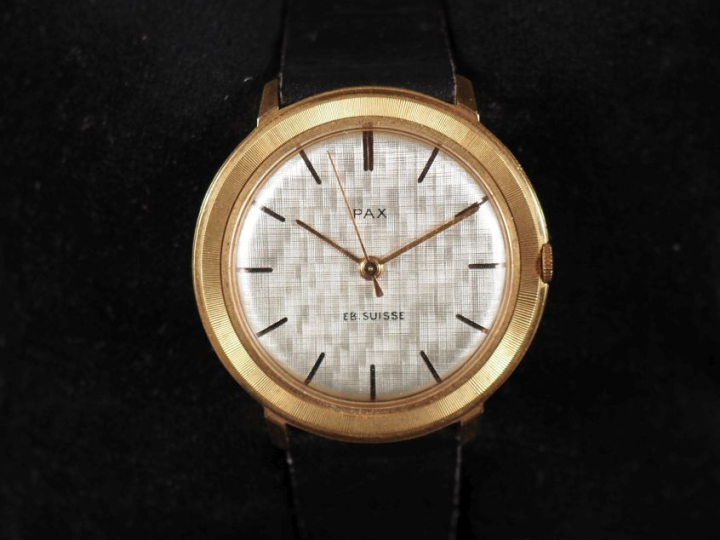 PAX Montre bracelet plate en métal doré.  Cadran à fond argenté et ind