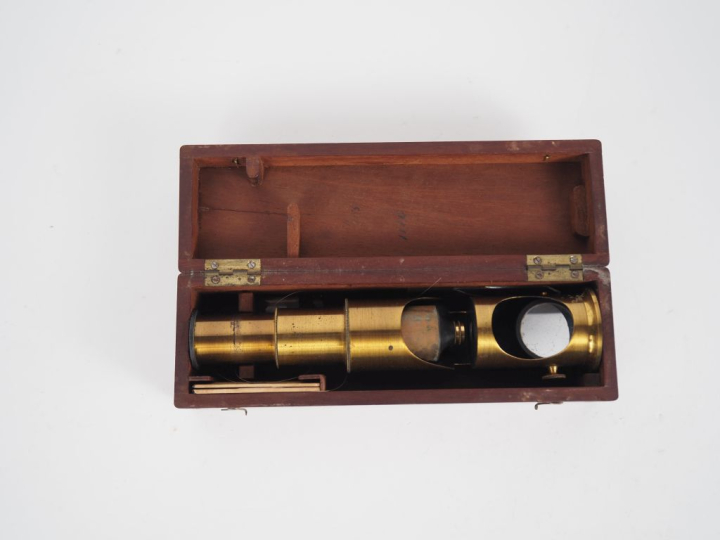 Microscope en laiton dans son coffret en bois. H. 19 cm.