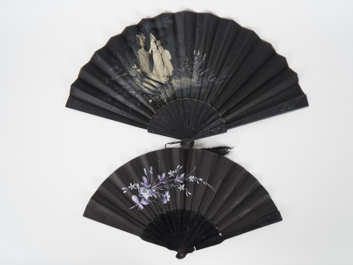 2 différents éventails en bois noirci et textile à décor de personnage