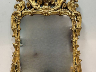 Vente aux enchères Glace Louis XV en bois sculpté et doré, à décor de fleurs, de rocaille