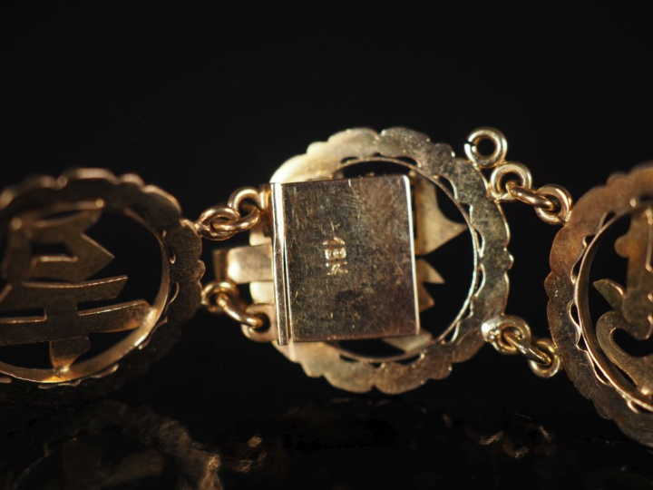 Bracelet souple en or jaune 585, composé de maillons ronds ajourés, à 