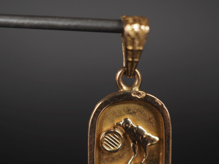 Pendentif en or jaune 750, à décor de hiéroglyphes.  H. 3,7 cm Poids. 