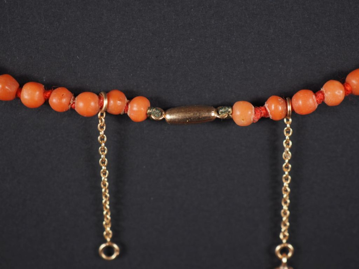 Collier de perles de corail disposées en chute. Fermoir et chainette d