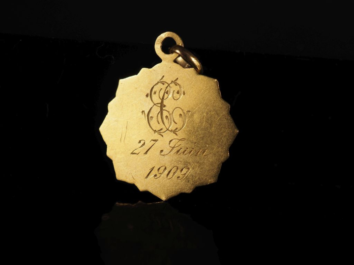 Médaille religieuse en or jaune 750, à décor de calice.  Joli pourtour
