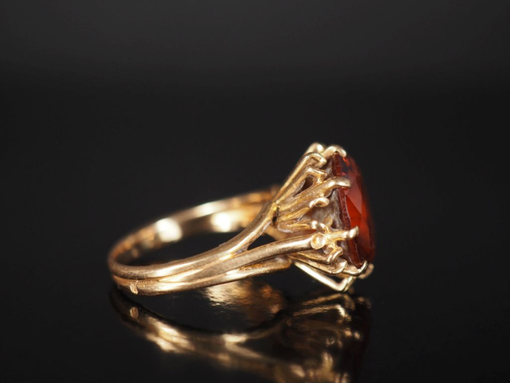 Bague en or jaune 750, sertie en son centre d'une topaze.  TDD. 54 Poi