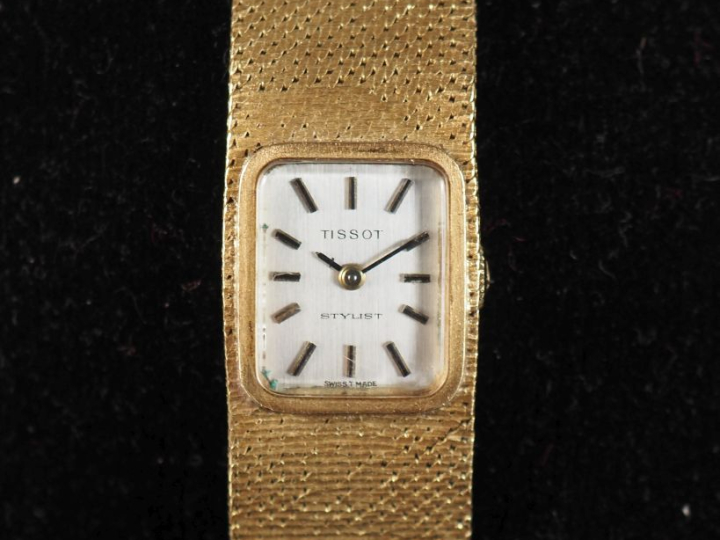 TISSOT, Stylist Montre bracelet de dame en or jaune 750.  Cadran recta