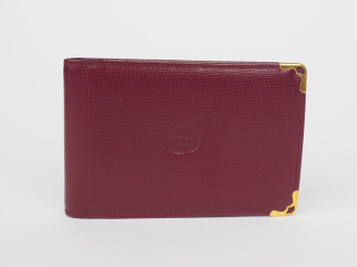 Vente aux enchères CARTIER, Paris Protège carnet en cuir bordeaux.  Deux coins gainés de 