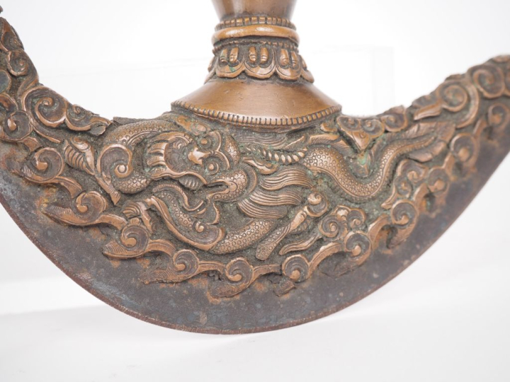 Tibet, XXe siècle Lot comprenant, un vajra à décor d’adorants et feuil