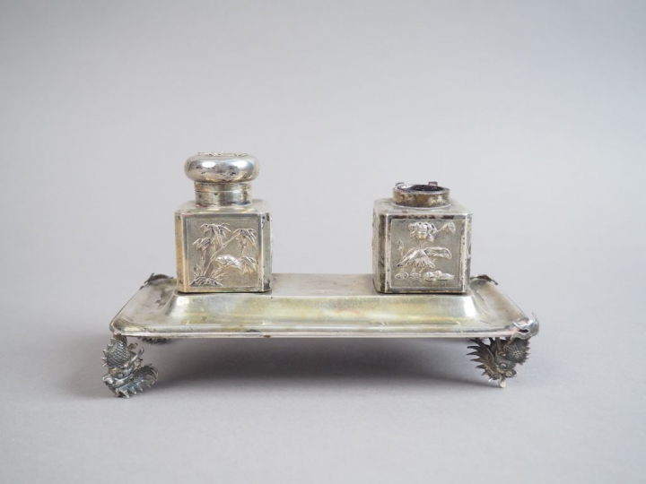 Encrier en argent, reposant sur quatre têtes de dragon.  Indochine, ve