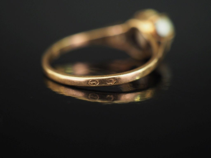 Bague en or jaune 375, sertie en son centre d'une perle blanche. TDD. 