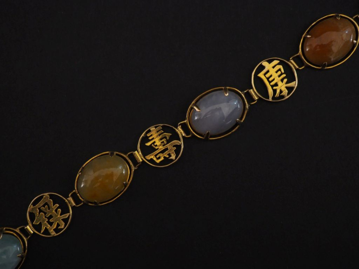 Bracelet articulé en or jaune 375, composé de maillons sertis de pierr
