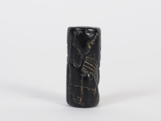 Vente aux enchères Orient ancien. Sceau cylindre en pierre noire figurant un bovidé dress