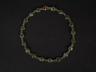 Vente aux enchères Bracelet souple en or jaune 375, orné de jadéite en médaillon.  Long. 
