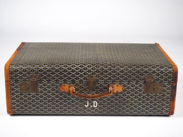 GOYARD Valise vintage en toile goyardine gainée de cuir marron.  Une a