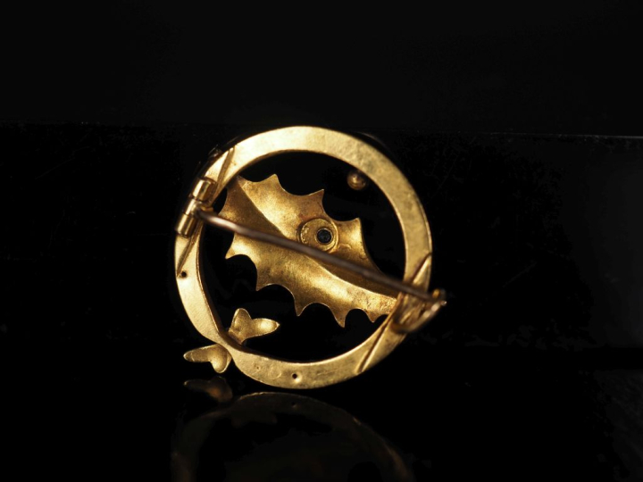 Broche ronde ajourée en or jaune 750, à décor d'une feuille de houx et