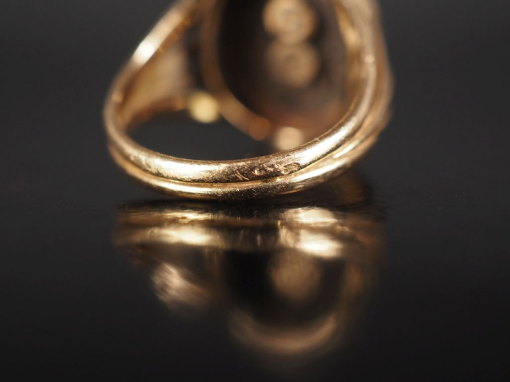 Bague de forme chevalière en or jaune 750 et onyx noir, à décor de mon