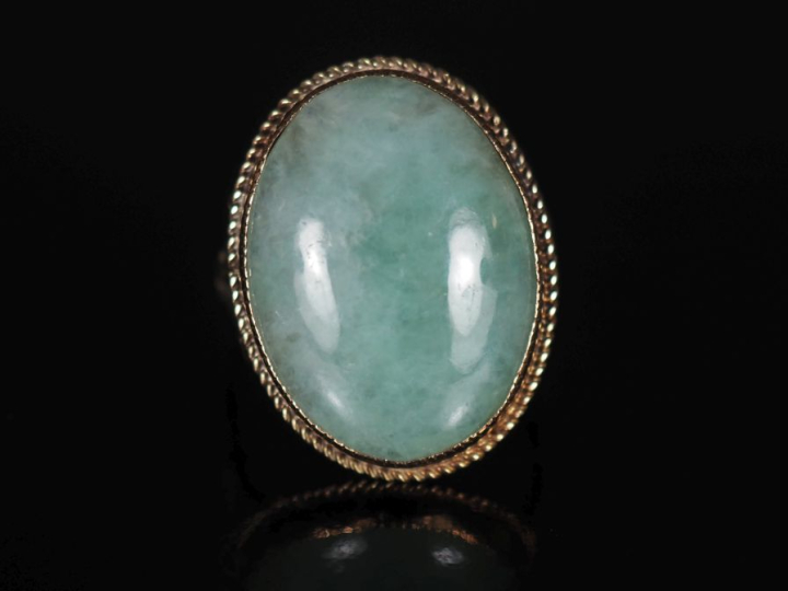 Bague en or jaune 375, sertie en son centre de jadéite en cabochon.  T