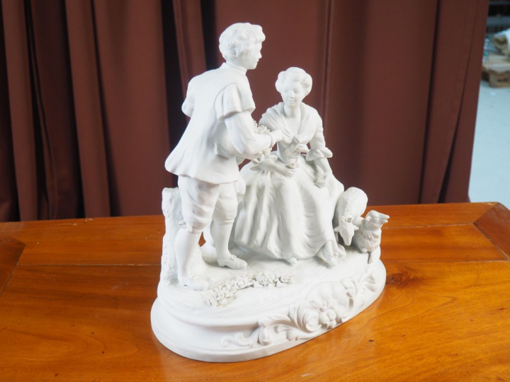 Groupe en biscuit, d’après BOUCHER.  « Scène galante » signé.  Dim. 7 